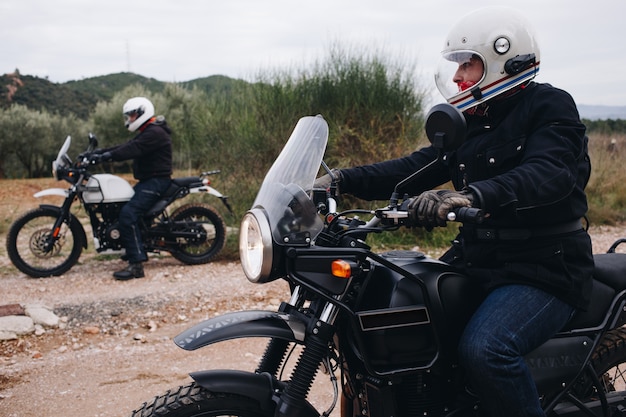 Group of friends ride motorcycles in forest