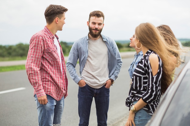 Free photo group of friends standing together on road