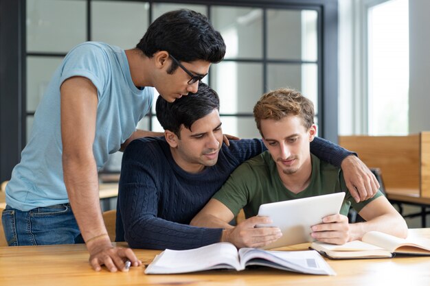 Group of friends studying together, helping each other
