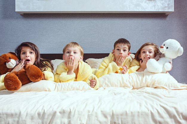 The group of friends taking goog time on bed