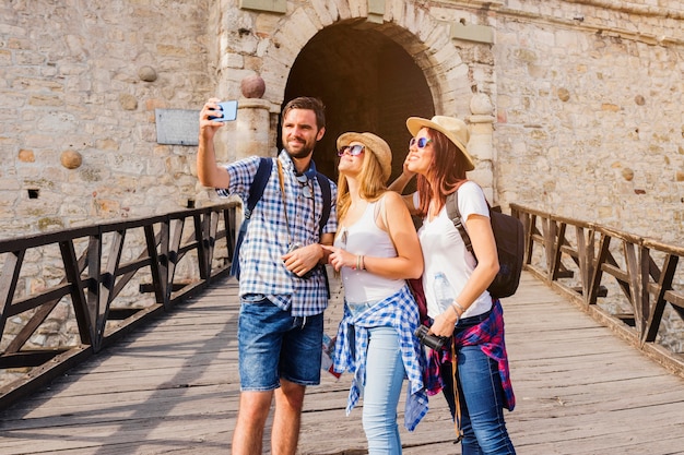 Group of friends taking selfie on cellphone