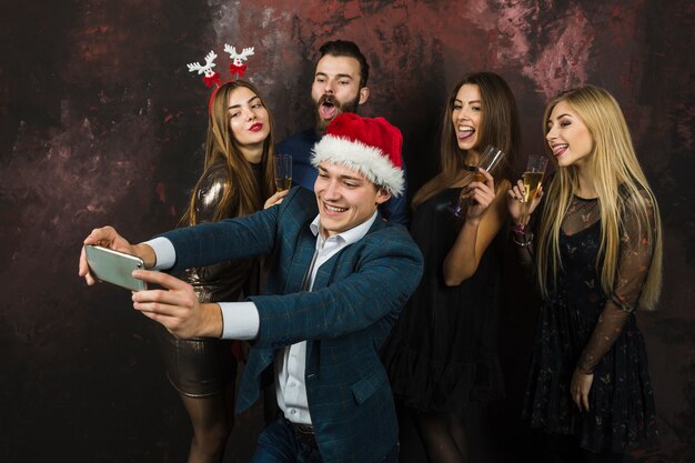 Free photo group of friends taking selfie of new year party