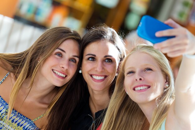 Group of friends taking selfie in the street.