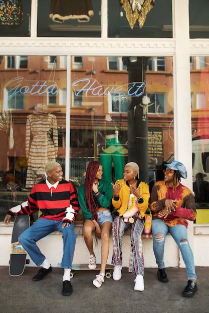 Group of friends talking outside a clothing store in the city