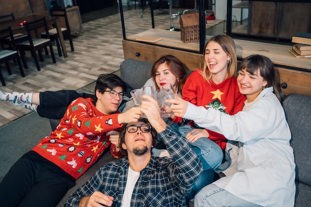 Group friends talking sitting in a couch in the living room