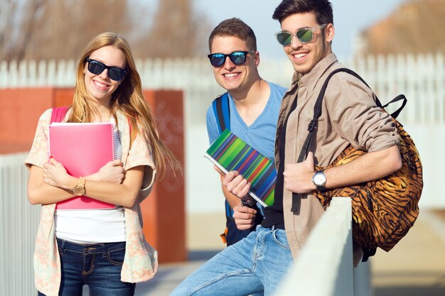 A group of friends talking in the street after class.