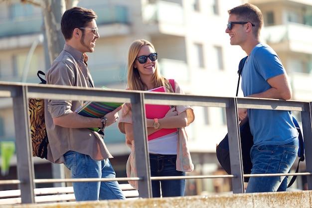 A group of friends talking in the street after class.