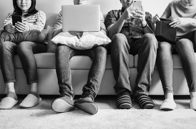 Group of friends using digital devices