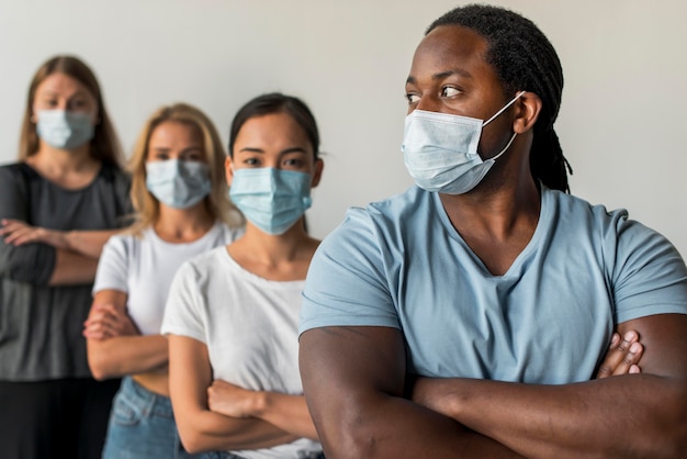 Free photo group of friends wearing face masks