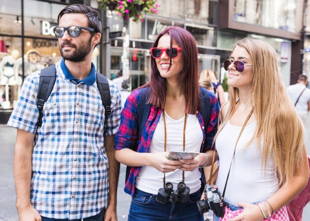 Group of friends wearing sunglasses in city