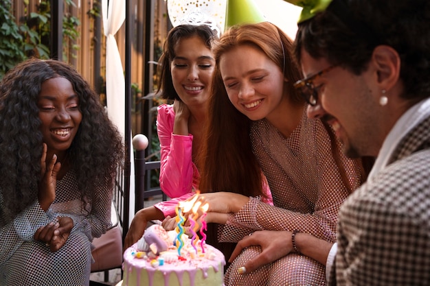 Group of friends with cake at a surprise birthday party