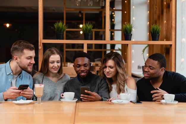 Group of friends with mobiles