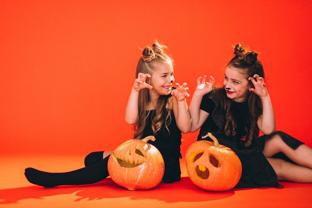 Group of girls dressed in halloween costumes in studio