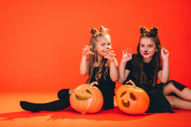 Group of girls dressed in halloween costumes in studio