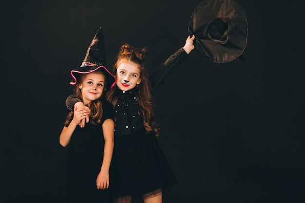 Group of girls dressed in halloween costumes in studio