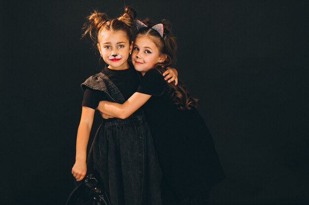 Group of girls dressed in halloween costumes in studio