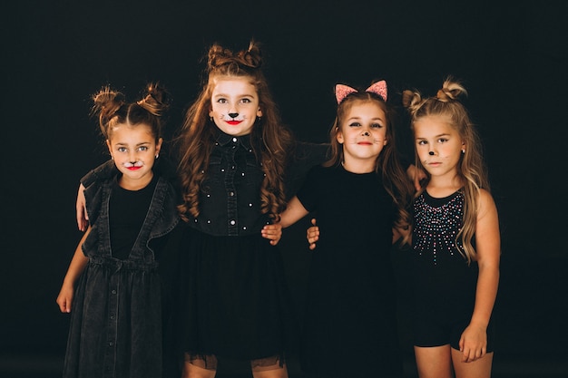 Group of girls dressed in halloween costumes in studio