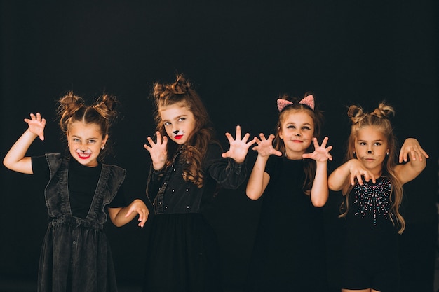 Group of girls dressed in halloween costumes in studio