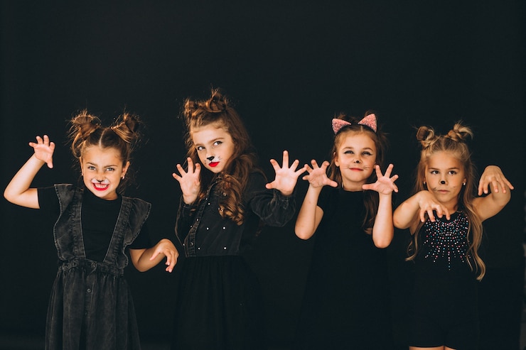 Free Photo group of girls dressed in halloween costumes in studio