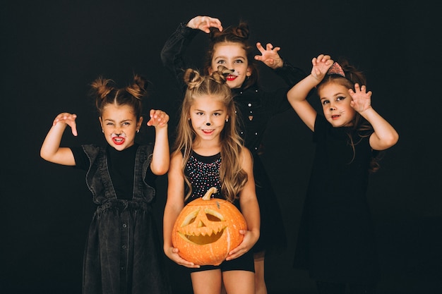 Group of girls dressed in halloween costumes in studio