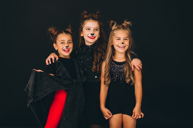 Group of girls dressed in halloween costumes in studio