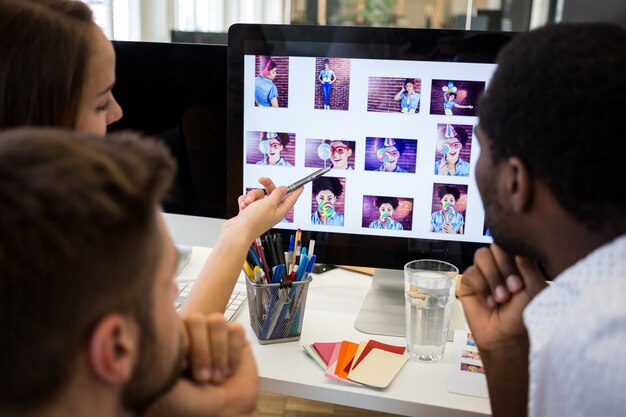 Group of graphic designers interacting over computer