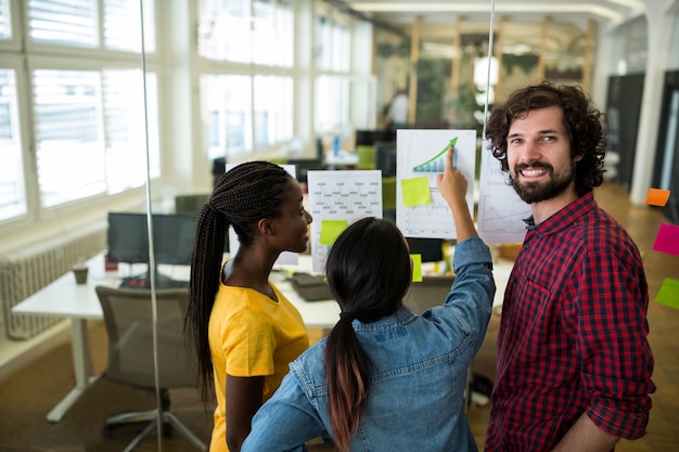 Free photo group of graphic designers interacting over a graph