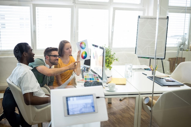 Group of graphic designers working on computer