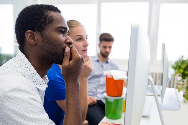 Group of graphic designers working on computer