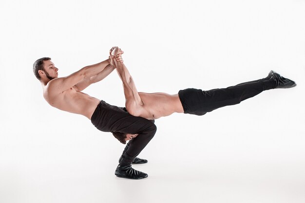 group of gymnastic acrobatic caucasian men on balance pose