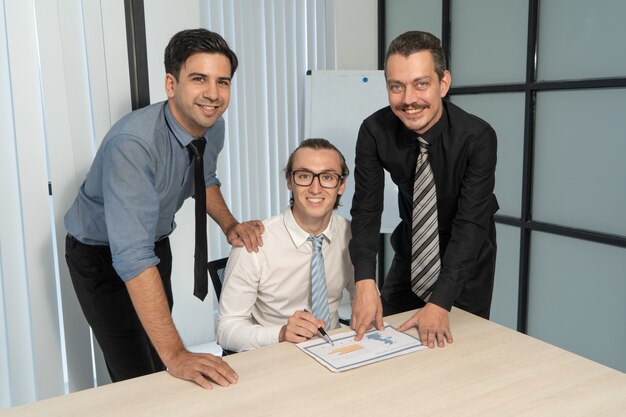 Group of happy business executives in meeting room.