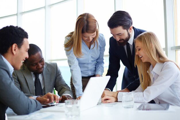 Group of happy businesspeople having a meeting