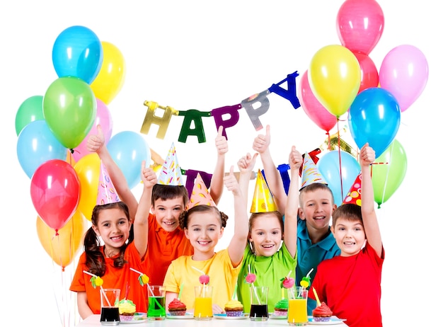 Group of happy children in colorful shirts having fun at the birthday party - isolated on a white
