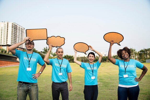 Group of happy and diverse volunteers with speech bubbles