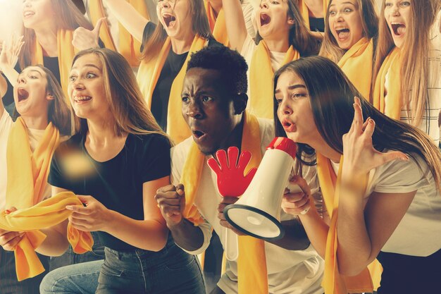 Group of happy fans are cheering for ir team victory.