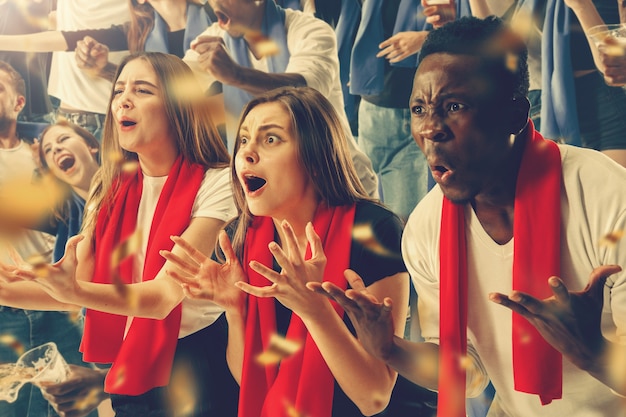 Group of happy fans are cheering for their team victory. Collage made of 8 models.