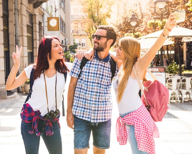 Group of happy friends having fun on street