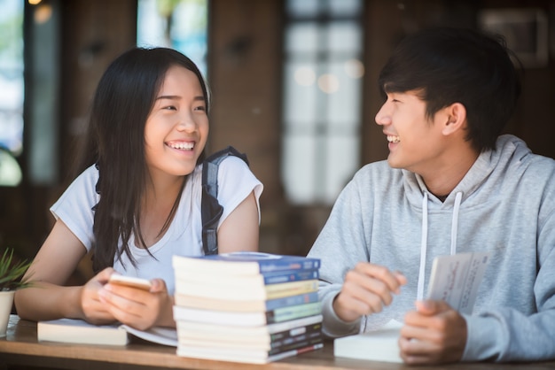 カフェで知識を話す幸せな友達の学生のグループ