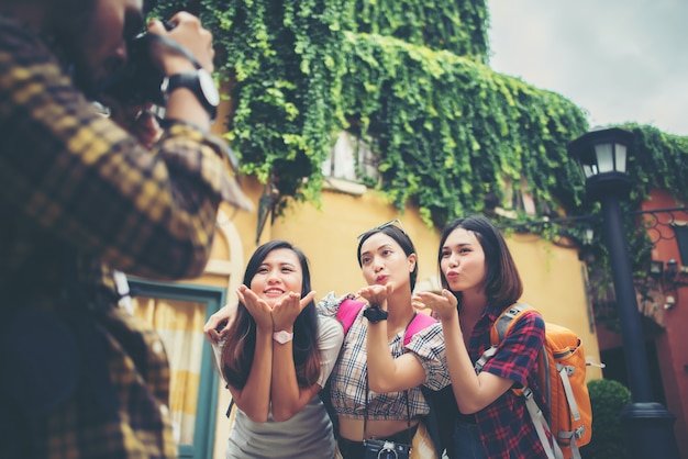 Group of happy friends taking selfies together in urban scene