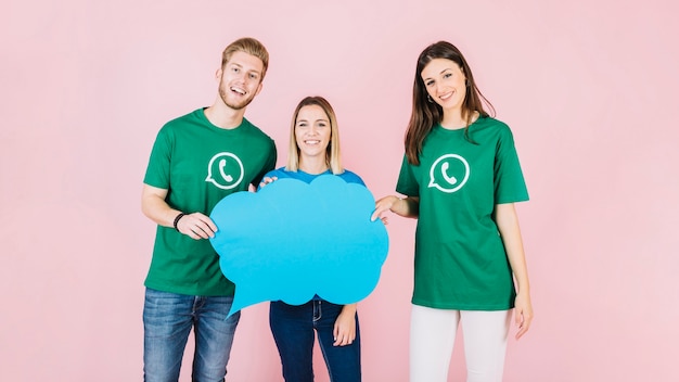 Group of happy friends with blue speech bubble on pink background