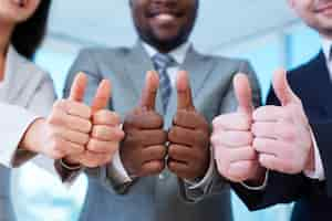 Free photo group of happy workmates showing thumbs up