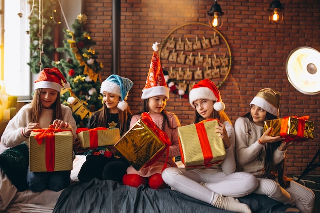 Free photo group of kids sitting sitting with presents