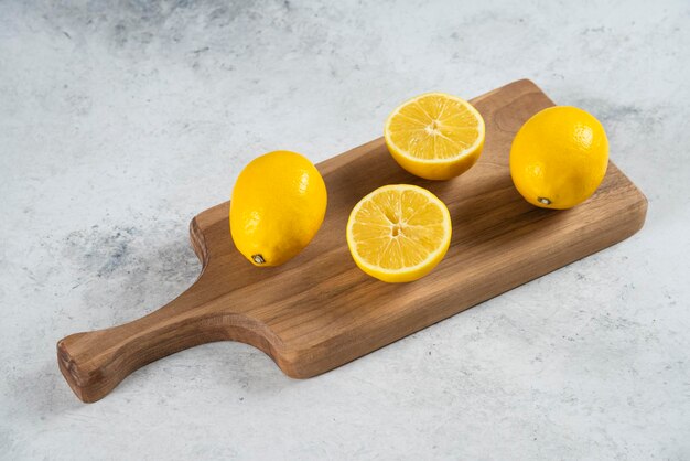 Group of lemon fruits on a wooden board .