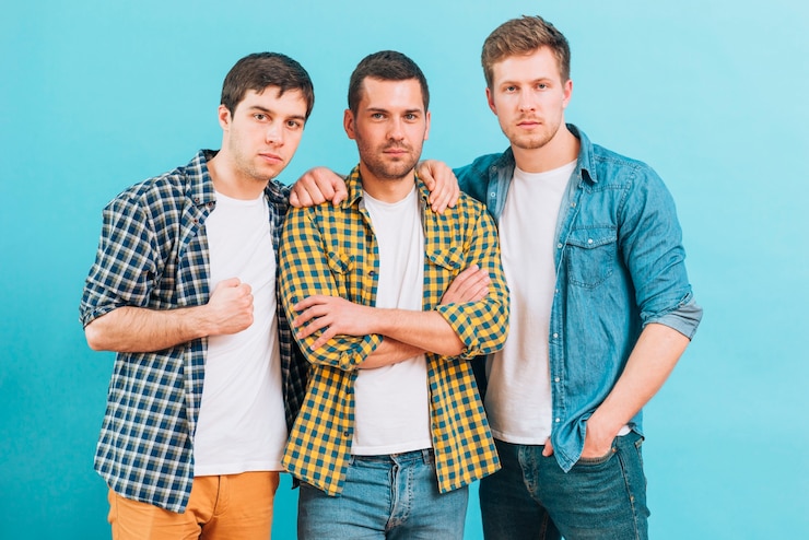 Free Photo group of a male friends standing against blue background