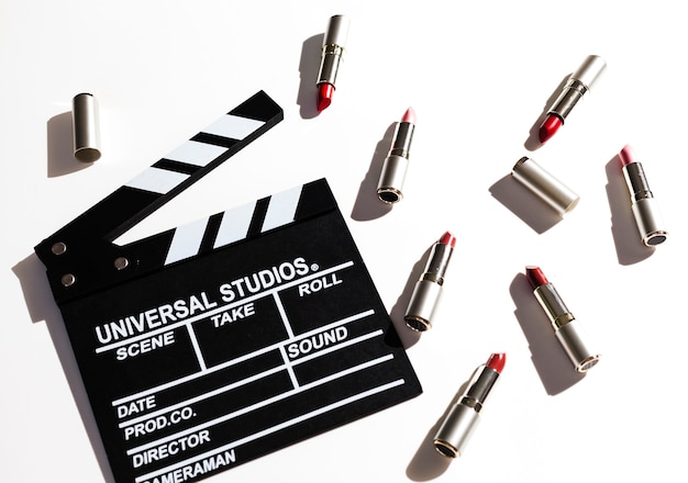 Group of metallic lipsticks with clapperboard