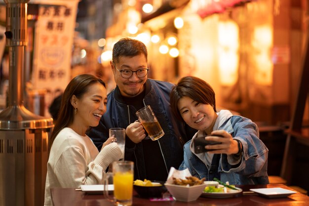 group of middle age friends having fun at night