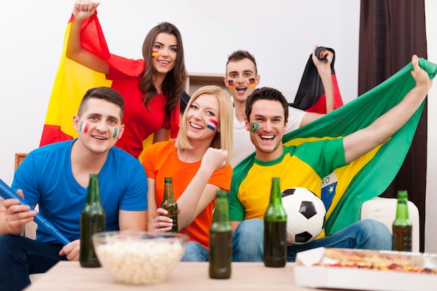 Group of multi national football fans cheering