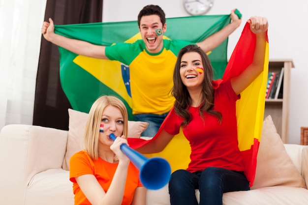 Group of multi national football fans cheering