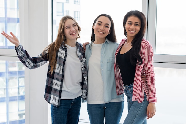 Group of multiethnic female friends hugging 