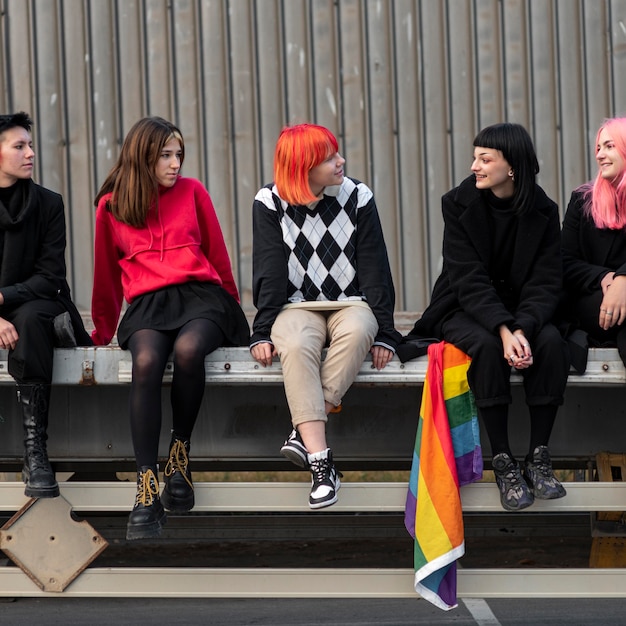 Free photo group of non binary friends sitting next to each other